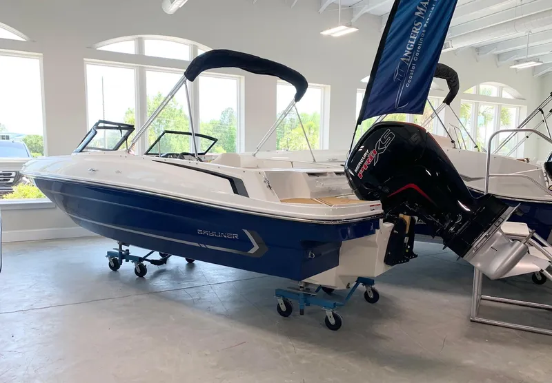 Slide: The Image of 2024 Bayliner VR4 boat in showroom with outboard motor. - 0