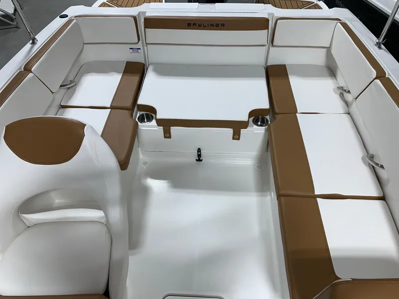 Slide: The Image of 2024 Bayliner VR4 boat interior with white and brown seating. - 10