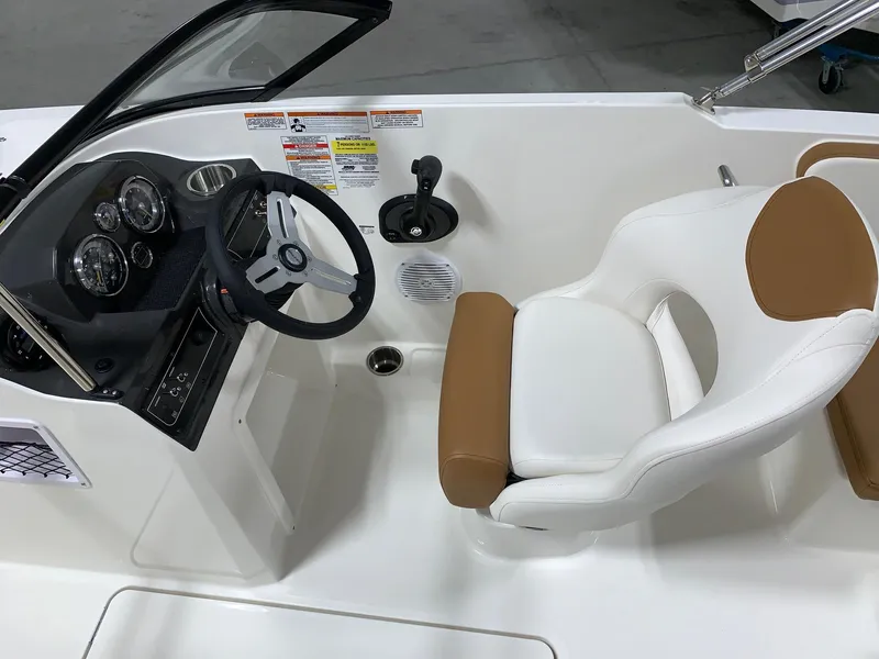 Slide: The Image of 2024 Bayliner VR4 boat cockpit with steering wheel, gauges, and white captain's chair. - 13