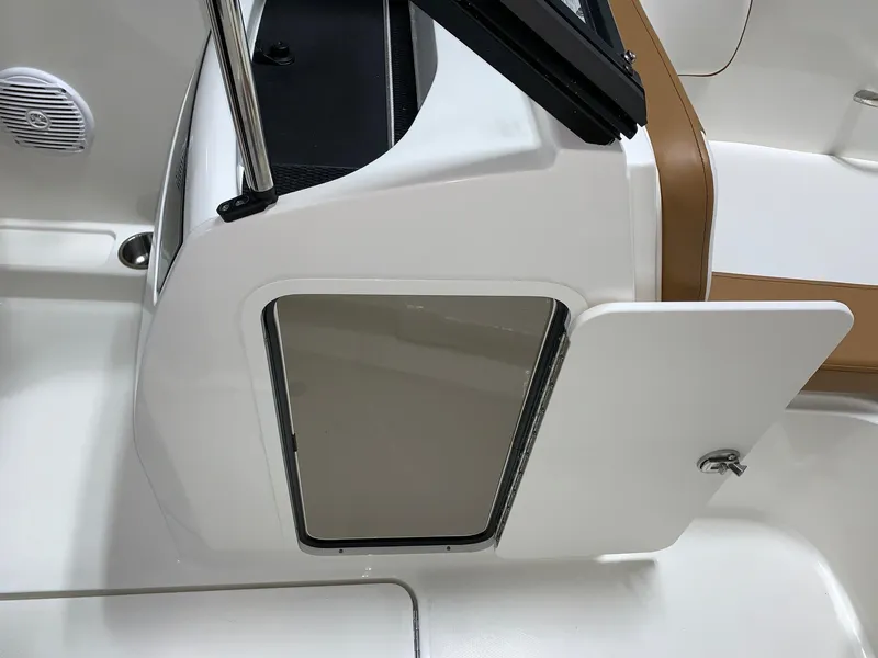 Slide: The Image of 2024 Bayliner VR4 boat interior storage compartment with open door. - 15