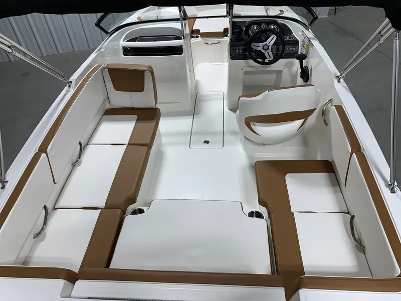 Slide: The Image of 2024 Bayliner VR4 boat interior with white and brown seating. - 4