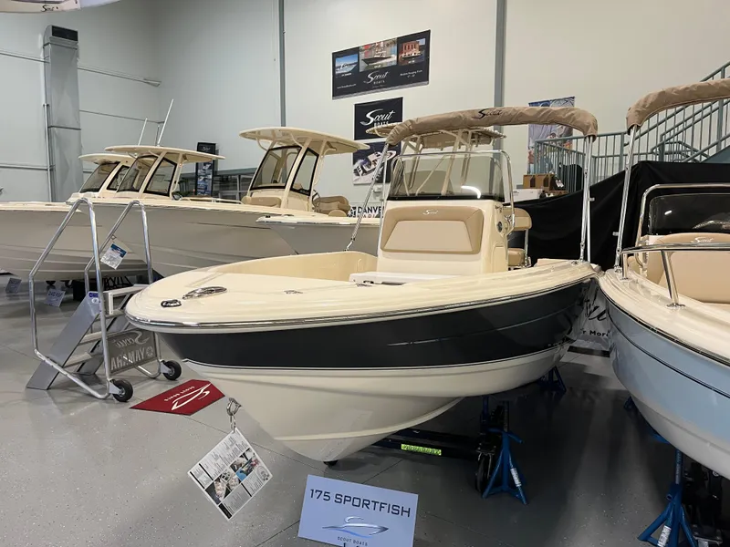 Slide: The Image of 2024 Scout 175 Sportfish boat displayed in showroom, featuring sleek design and modern amenities. - 2