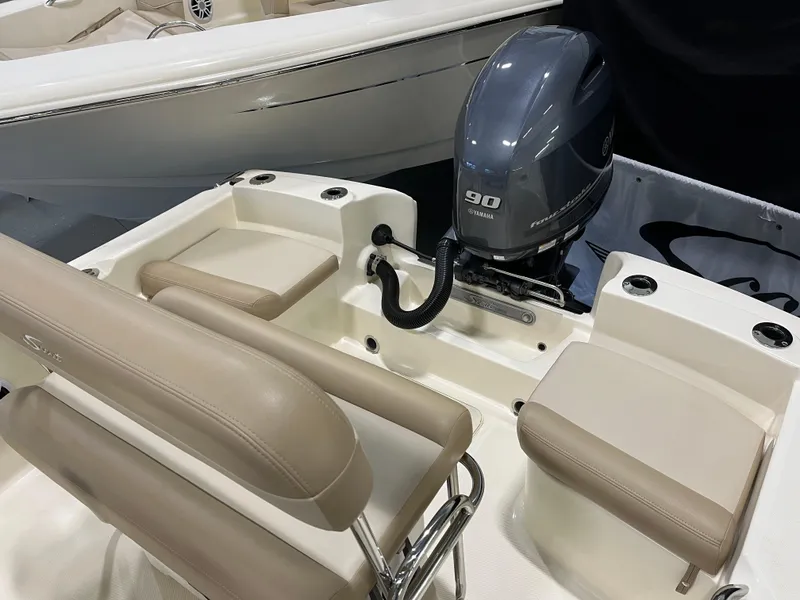 Slide: The Image of 2024 Scout 175 Sportfish boat with Yamaha 90 engine and beige seating. - 8