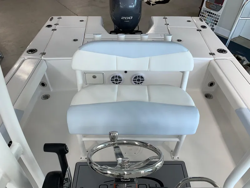Slide: The Image of 2024 Robalo 226 Cayman boat interior with steering wheel and seating. - 11