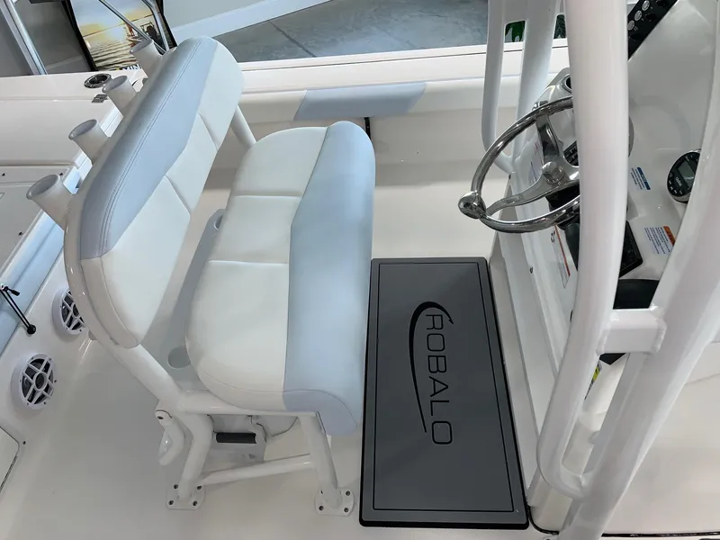 Slide: The Image of 2024 Robalo 226 Cayman boat interior with dual seats and steering console. - 12