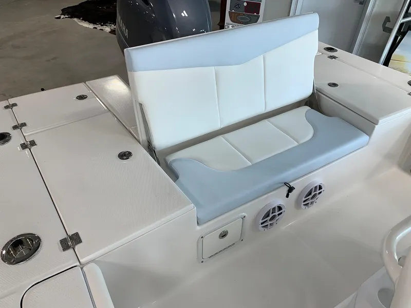 Slide: The Image of 2024 Robalo 226 Cayman boat seating area with white and light blue cushions. - 16