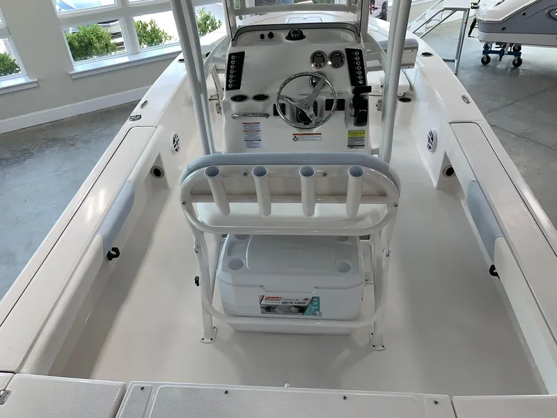 Slide: The Image of 2024 Robalo 226 Cayman center console boat interior with steering wheel and seating. - 19