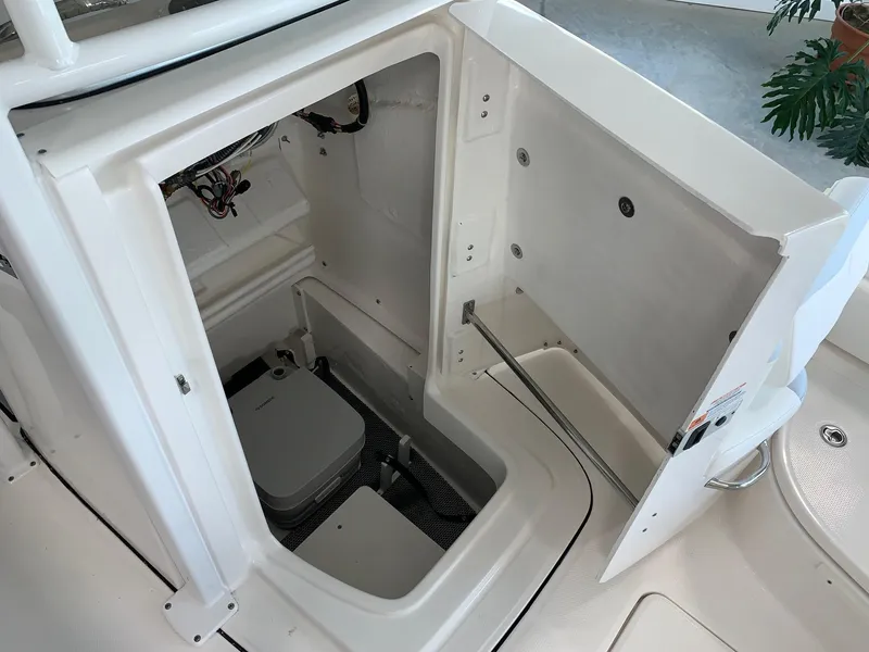 Slide: The Image of 2024 Robalo 226 Cayman boat storage compartment with open hatch. - 4