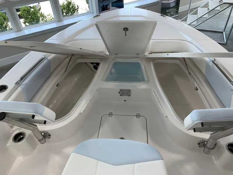 Slide: The Image of 2024 Robalo 226 Cayman boat interior with open storage compartments. - 10