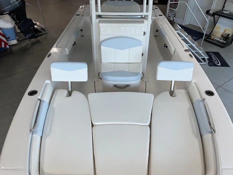 Slide: The Image of 2024 Robalo 226 Cayman boat interior with white cushioned seating. - 6