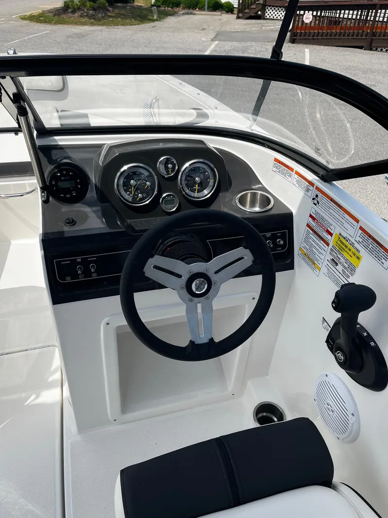 Slide: The Image of 2024 Bayliner VR4 boat dashboard with steering wheel and instrument panel. - 12