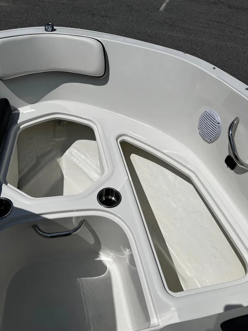 Slide: The Image of 2024 Bayliner VR4 boat interior storage compartments and seating area. - 14