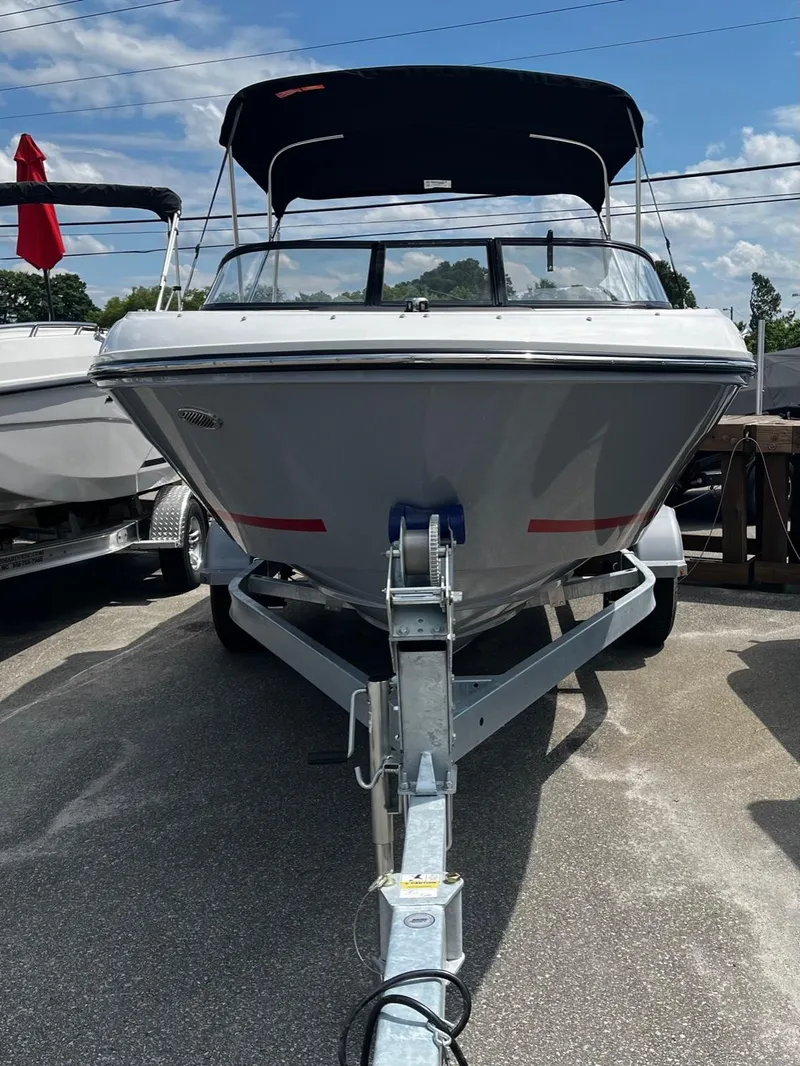 Slide: The Image of 2024 Bayliner VR4 boat on trailer with black canopy. - 2