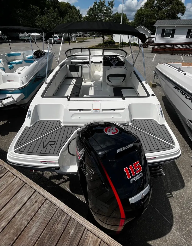 Slide: The Image of 2024 Bayliner VR4 boat with Mercury 115 outboard motor, docked and ready for use. - 3