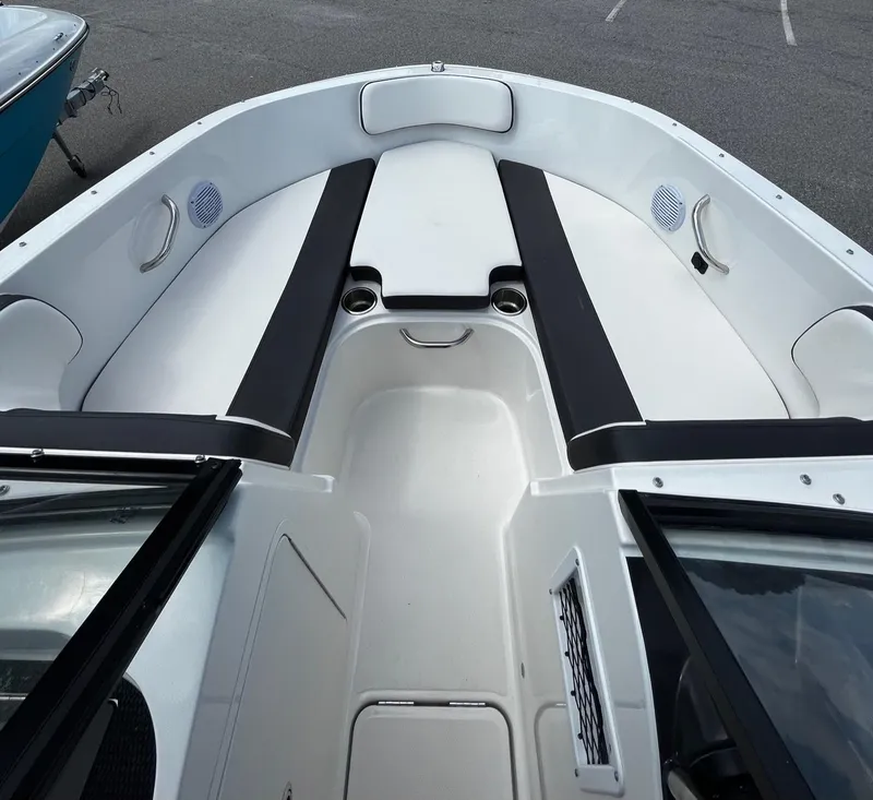 Slide: The Image of 2024 Bayliner VR4 boat interior with spacious seating and cup holders. - 5