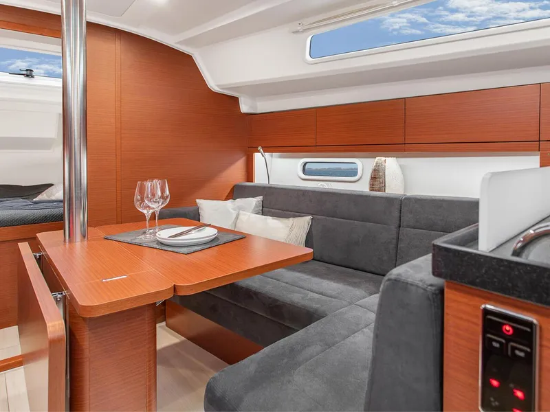 Slide: The Image of Interior of 2024 Hanse 348 sailboat with modern dining area and grey upholstery. - 21