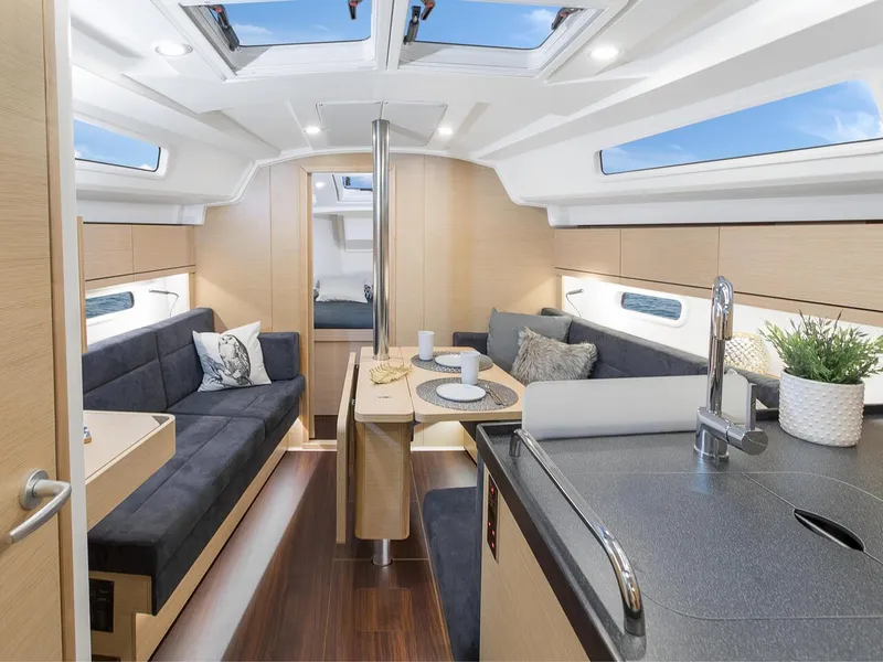 Slide: The Image of 2024 Hanse 348 yacht interior with modern design, skylights, and cozy seating area. - 9