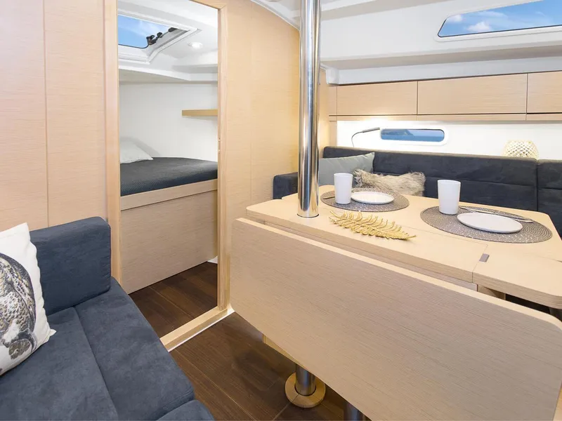 Slide: The Image of 2024 Hanse 348 yacht interior with modern dining area and cozy cabin. - 12
