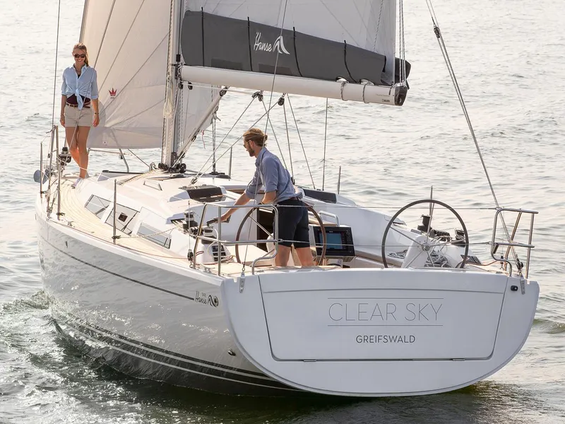 Slide: The Image of 2024 Hanse 348 sailboat Clear Sky sailing with two people on board. - 2