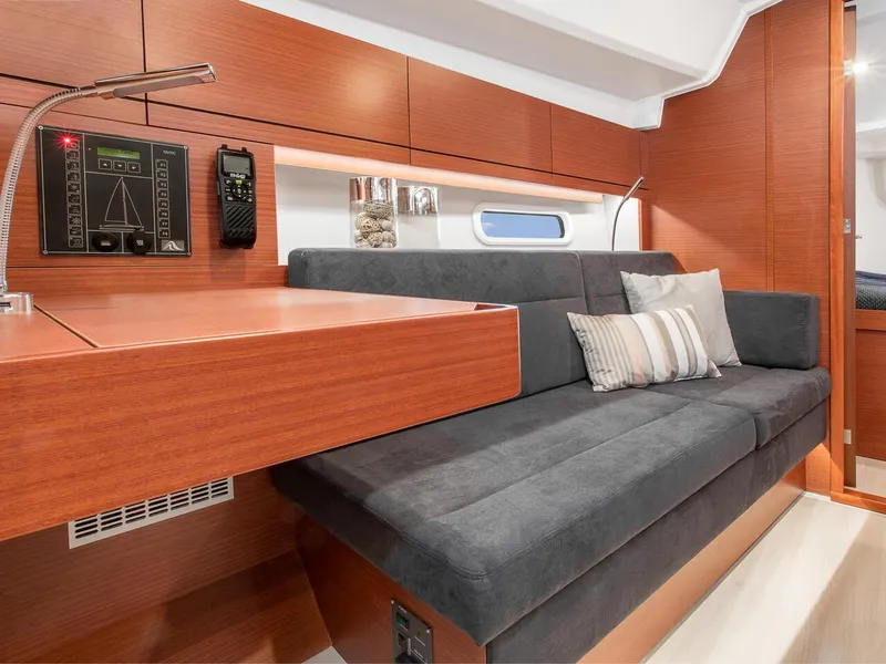 Slide: The Image of Interior of 2024 Hanse 348 sailboat with modern wood finish and grey seating. - 20