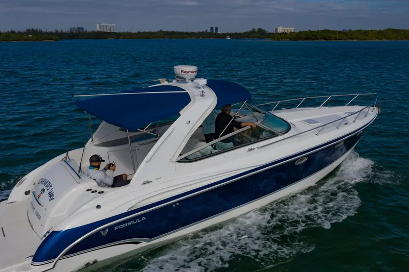 Slide: The Image of 2007 Formula 370 Super Sport boat cruising on blue water. - 12