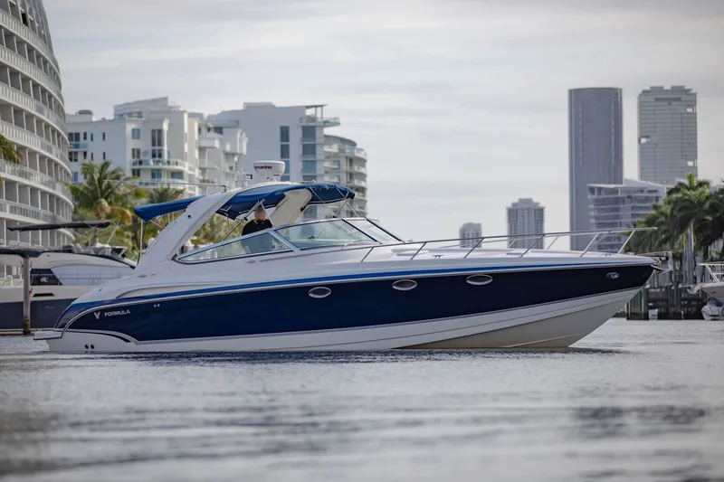 Slide: The Image of 2007 Formula 370 Super Sport boat cruising near modern city skyline. - 15