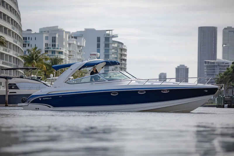 Slide: The Image of 2007 Formula 370 Super Sport boat cruising near modern city skyline. - 18