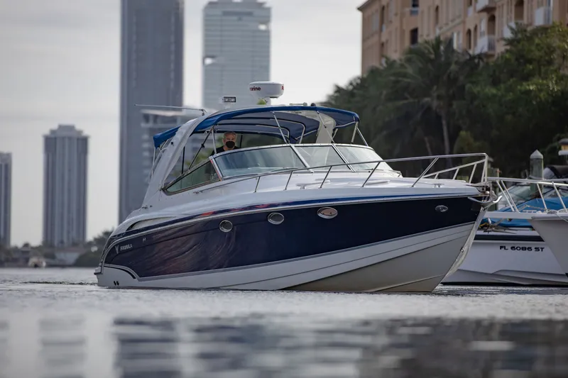 Slide: The Image of 2007 Formula 370 Super Sport boat cruising near city skyline. - 19