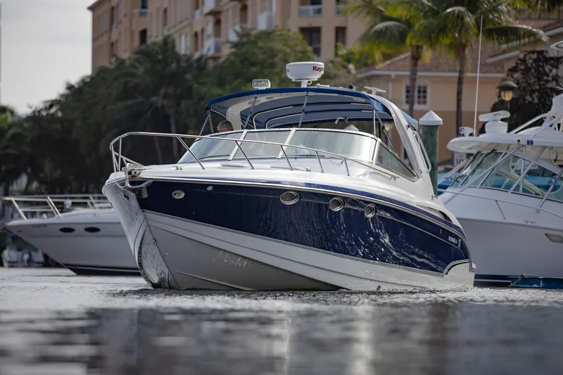 Slide: The Image of 2007 Formula 370 Super Sport boat docked in a marina, surrounded by palm trees. - 20