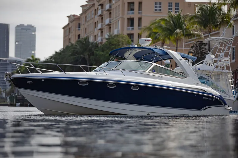 Slide: The Image of 2007 Formula 370 Super Sport boat on water near city buildings and palm trees. - 21