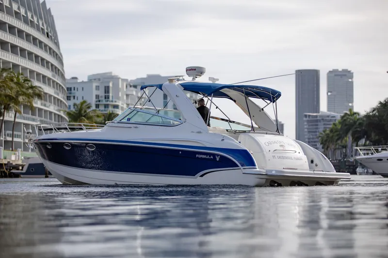 Slide: The Image of 2007 Formula 370 Super Sport boat cruising near city waterfront. - 22