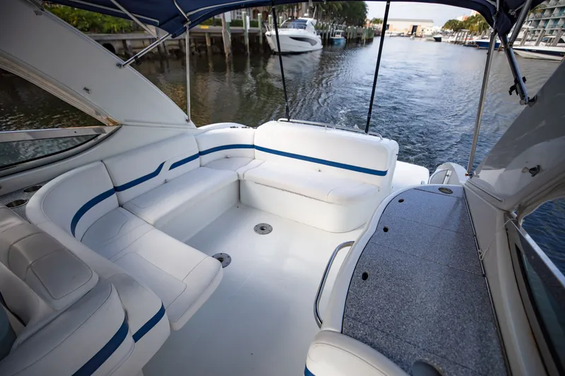 Slide: The Image of 2007 Formula 370 Super Sport boat interior with white seating and blue accents on a calm waterway. - 33