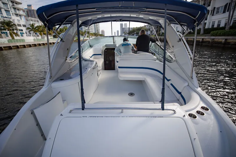 Slide: The Image of 2007 Formula 370 Super Sport boat with blue canopy on a calm waterway. - 36