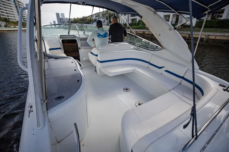 Slide: The Image of 2007 Formula 370 Super Sport boat with spacious seating and canopy on a calm waterway. - 37