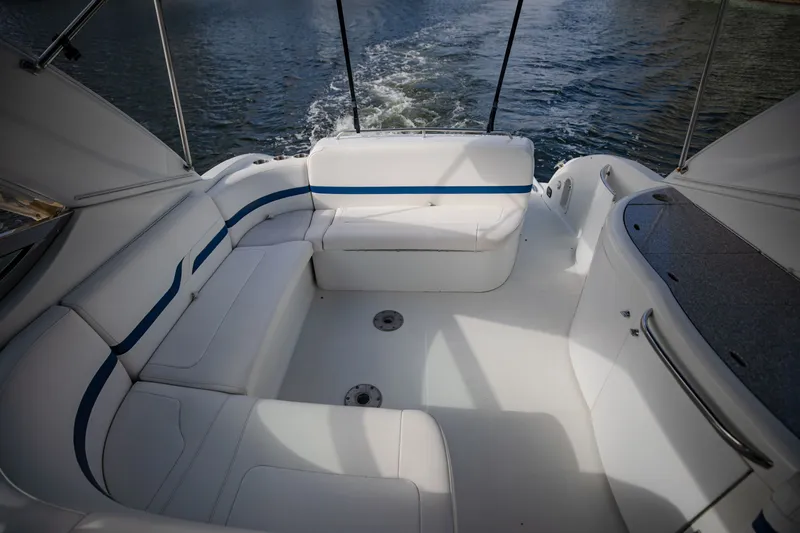 Slide: The Image of 2007 Formula 370 Super Sport boat interior with white seating and blue accents on the water. - 40