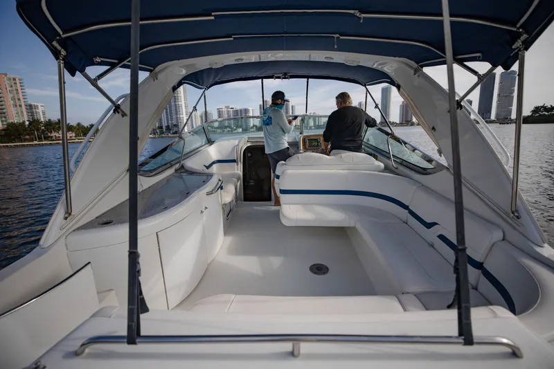 Slide: The Image of 2007 Formula 370 Super Sport boat interior with two people, city skyline in background. - 41