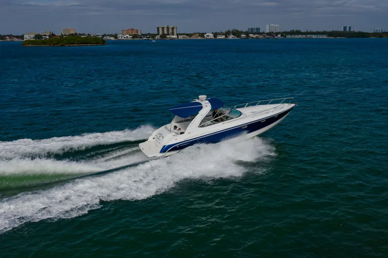 Slide: The Image of 2007 Formula 370 Super Sport cruising on open water, cityscape in background. - 8