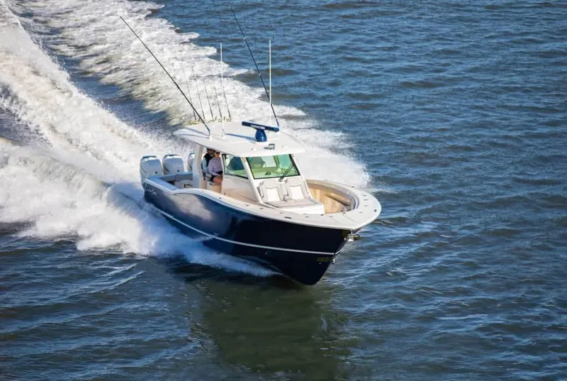 The Image of 2025 Scout 425 LXF boat cruising on open water. - 0