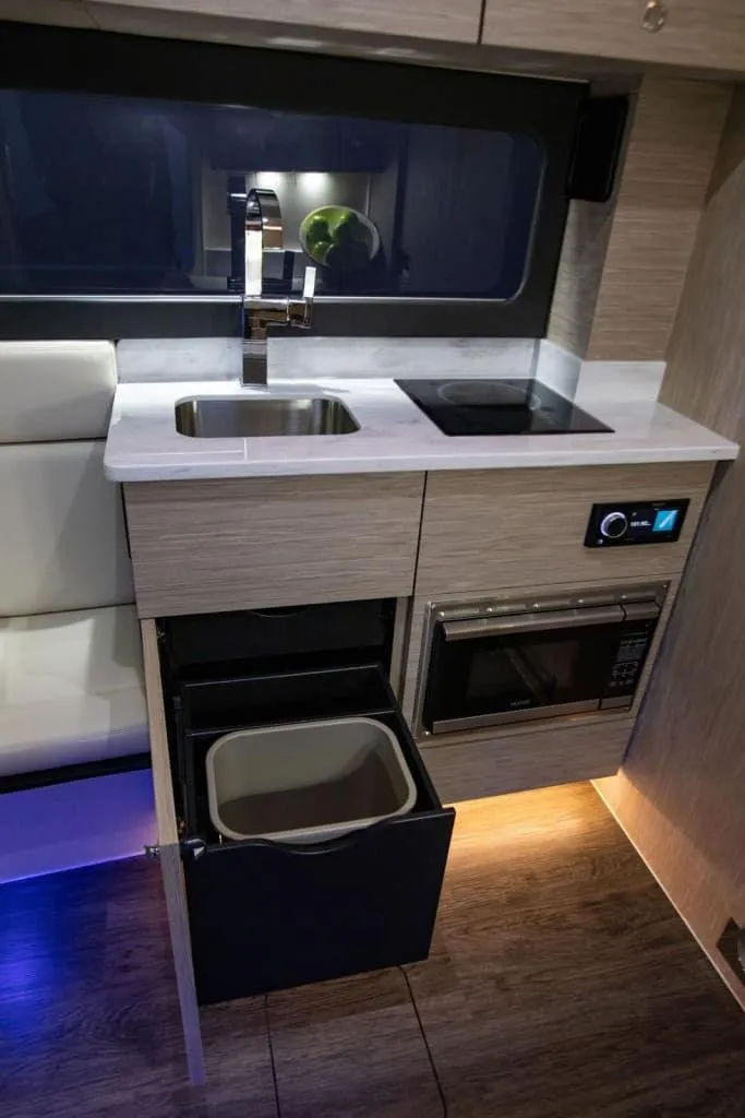 Slide: The Image of Modern kitchen in 2025 Scout 425 LXF boat with sink, stove, and microwave. - 13