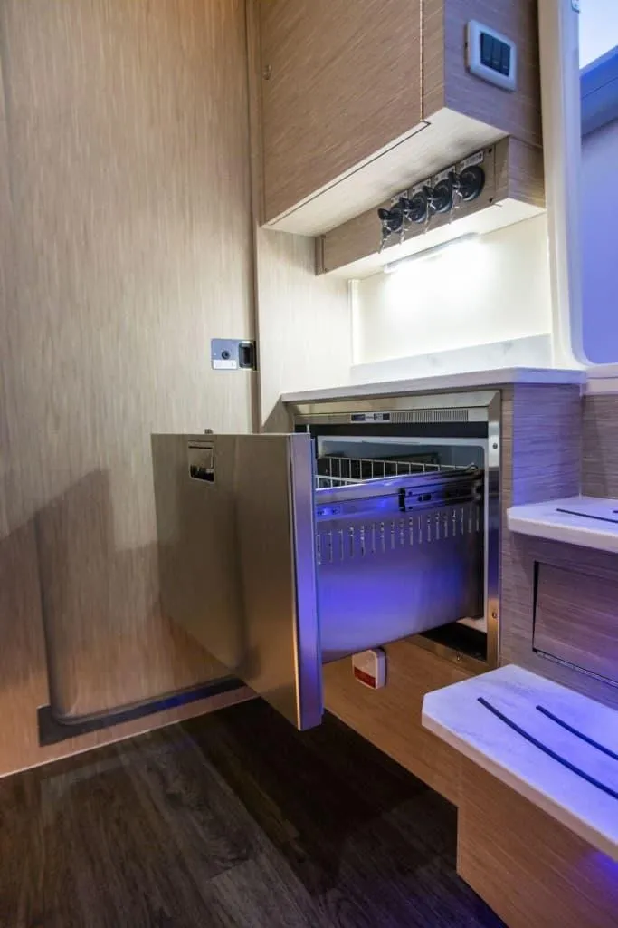 Slide: The Image of 2025 Scout 425 LXF interior with modern drawer and ambient lighting. - 14