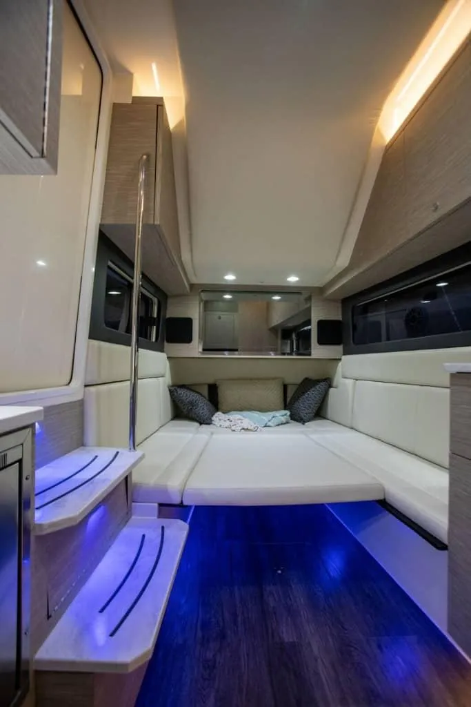Slide: The Image of Luxurious interior of 2025 Scout 425 LXF boat with ambient lighting and comfortable seating. - 16