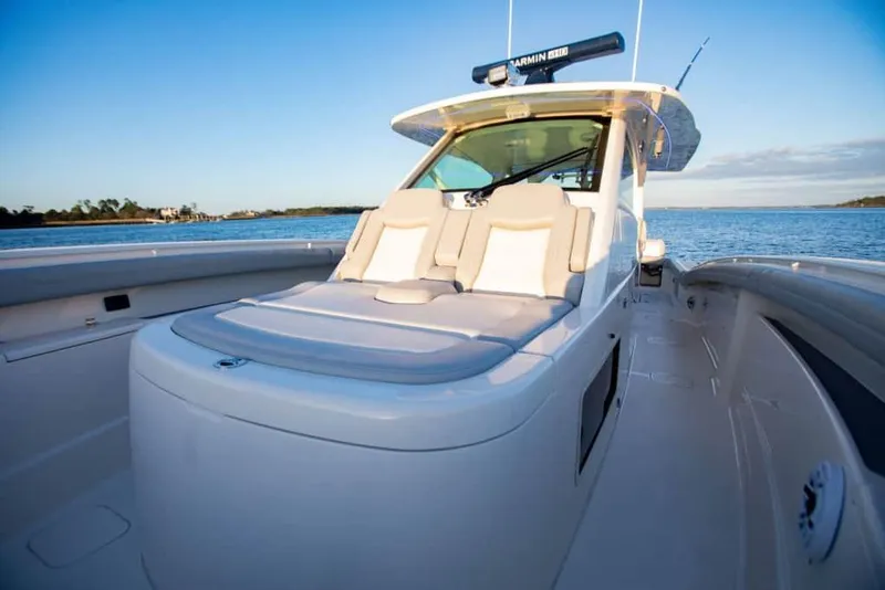 Slide: The Image of 2025 Scout 425 LXF luxury boat on calm waters, showcasing sleek design and comfortable seating. - 7