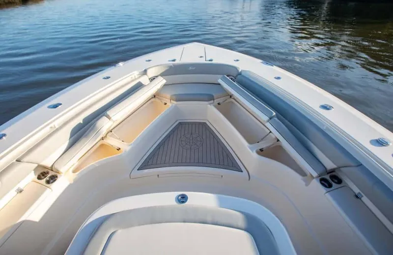 Slide: The Image of 2025 Scout 425 LXF boat interior with spacious seating and elegant design on calm water. - 8