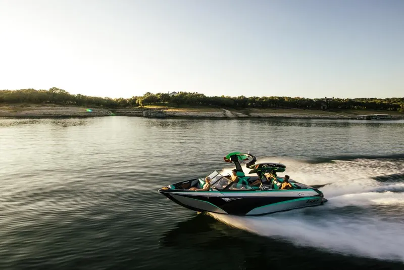Slide: The Image of 2023 Tigé Z3 boat cruising on a lake at sunset. - 1