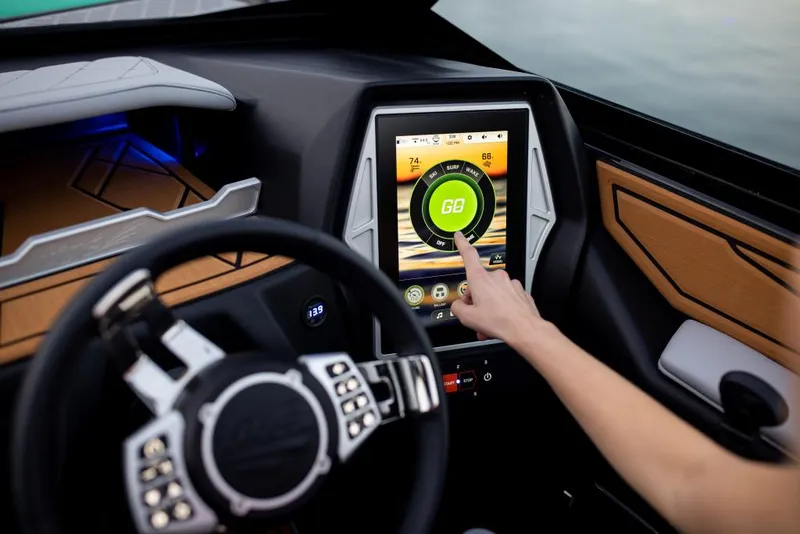 Slide: The Image of 2023 Tigé Z3 boat dashboard with touchscreen controls and steering wheel. - 4