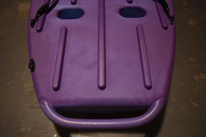 Slide: The Image of Purple Ascend 9R Sport Sit-On kayak, 2021 model, featuring dual handles and streamlined design. - 9