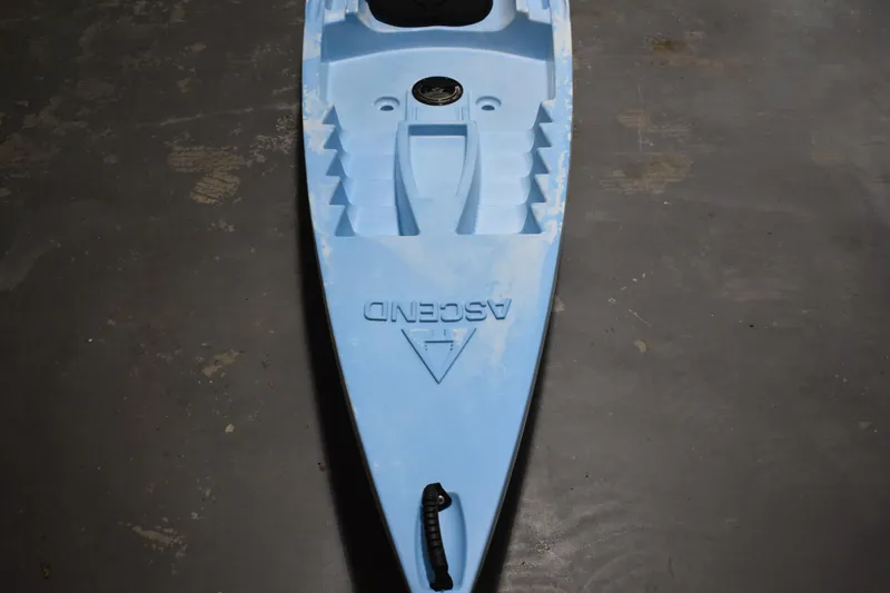 Slide: The Image of Blue Ascend 12R Sport Sit-On kayak, 2021 model, on a concrete floor. - 6