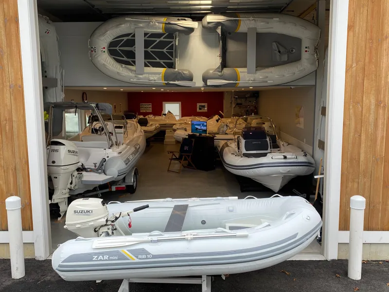 The Image of 2022 ZAR Mini Rib HDL10 inflatable boats displayed in a showroom. - 1