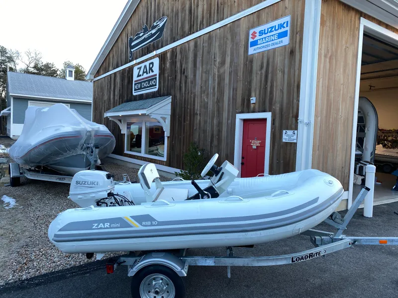 Slide: The Image of 2022 ZAR Mini Rib HDL10 inflatable boat on trailer outside dealership. - 10