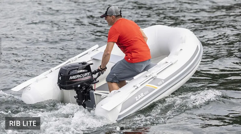 Slide: The Image of 2022 ZAR Mini Rib HDL10 inflatable boat with Mercury outboard motor on water. - 8